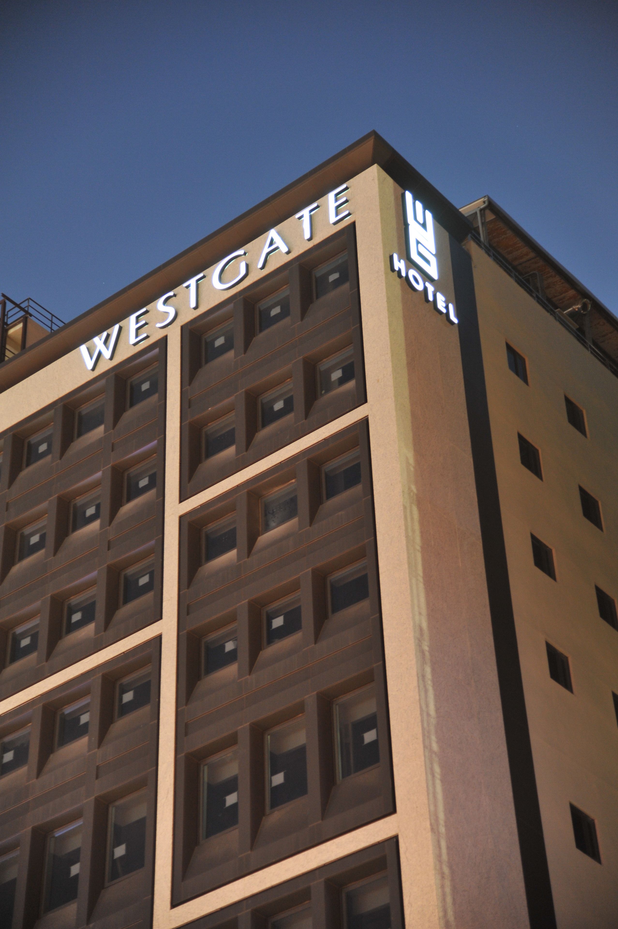 A multi-story building with the sign "WESTGATE HOTEL" on the facade.