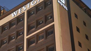 A multi-story building with the sign "WESTGATE HOTEL" on the facade.