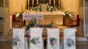 An altar with a religious icon, candles, and floral arrangements in a church setting. - Aparthotel Snjezna Kraljica (Stubicke Toplice)