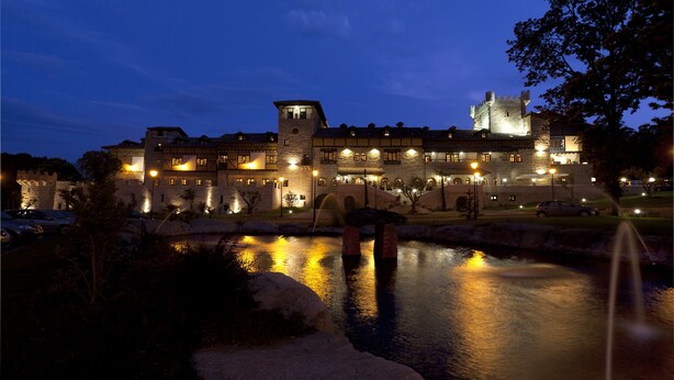A castle-like building with multiple levels and a moat at the front. - Hotel SPA Abadía de Los Templarios (La Alberca)