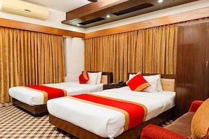 A hotel room with two beds, a wooden headboard, a checkered floor, and a large window with curtains. - Air Inn (Dhaka)
