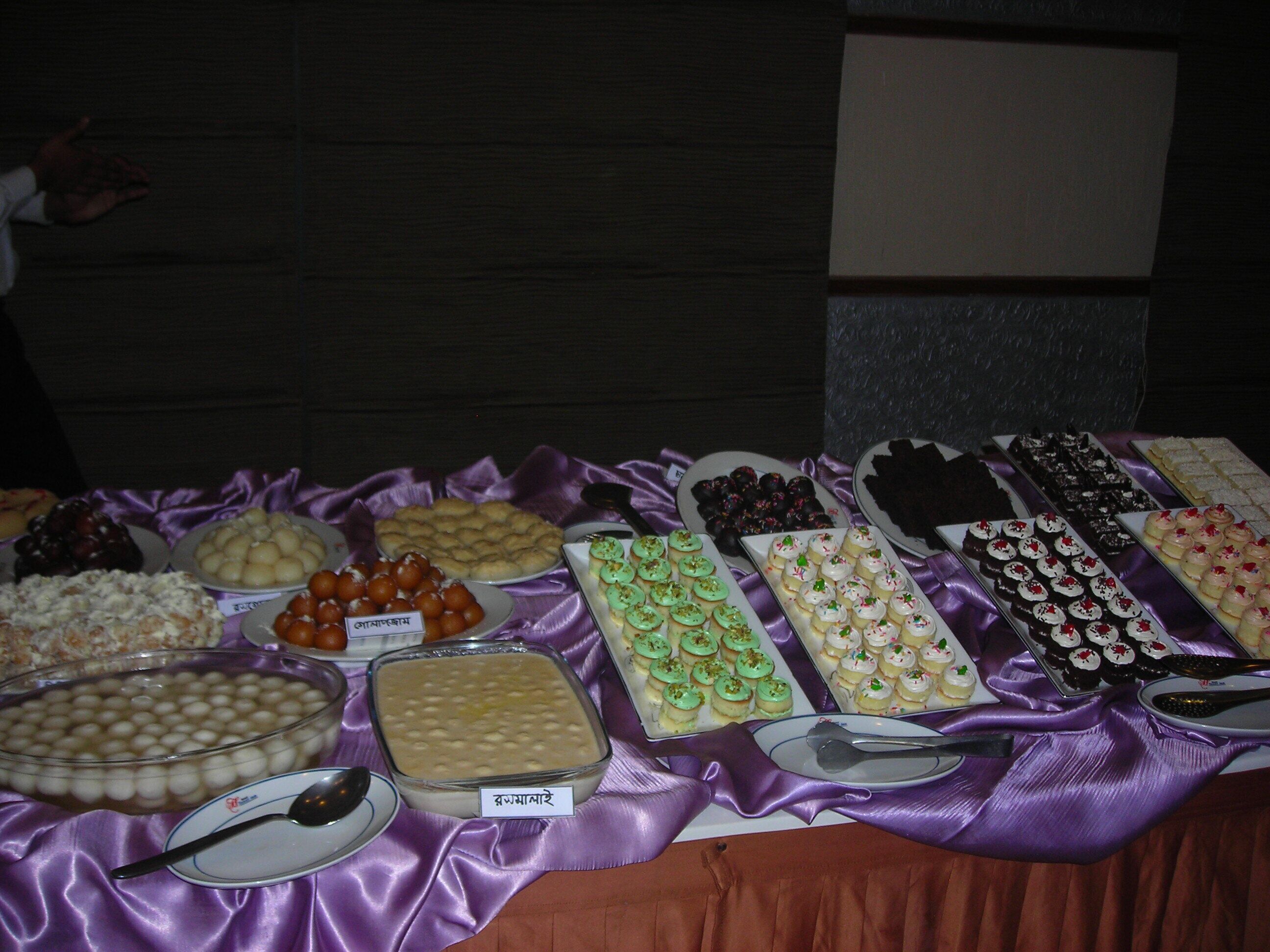 A buffet table with various desserts and snacks.