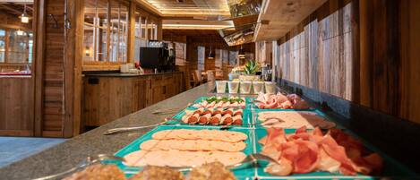 A buffet with various meats and vegetables.