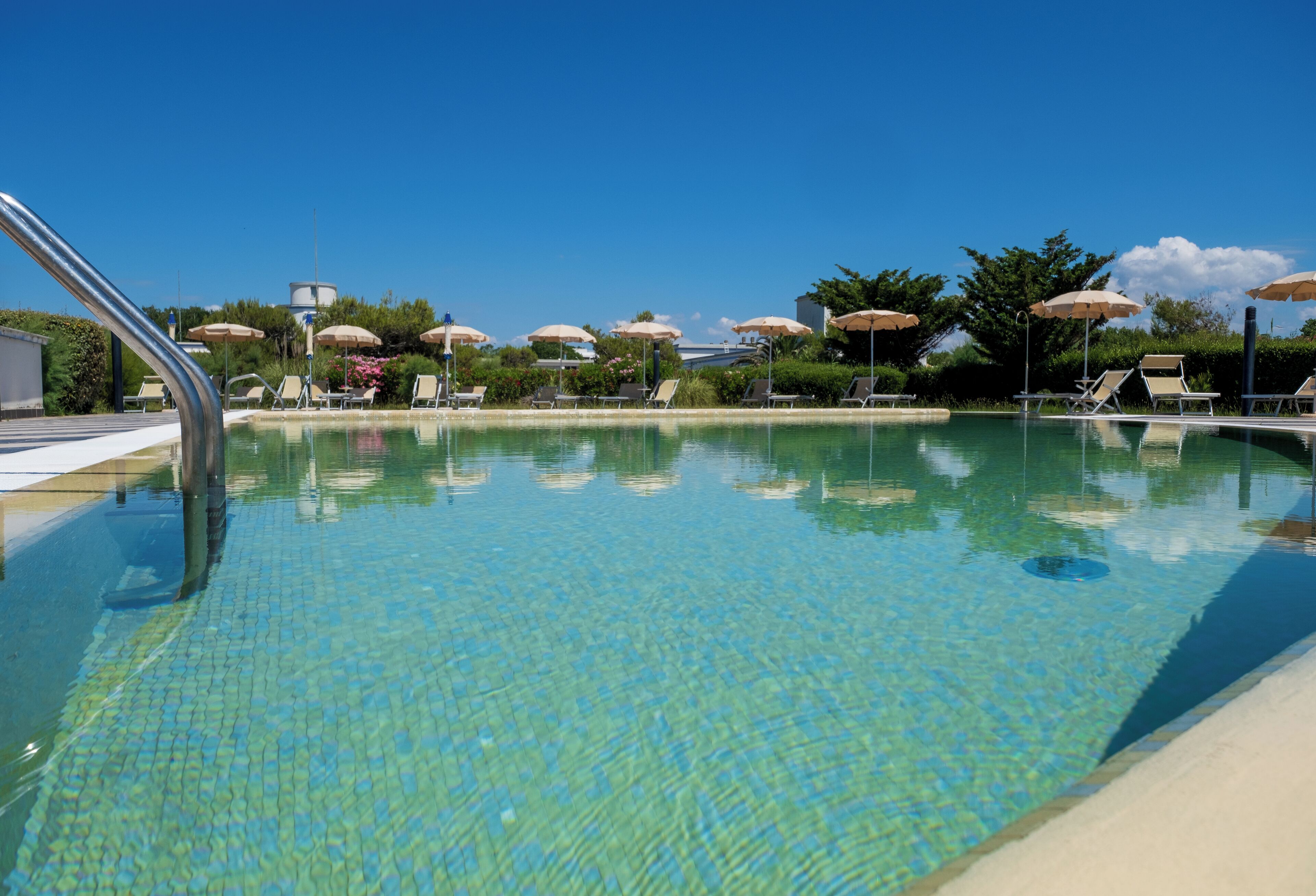 Seasonal outdoor pool, open 10:00 AM to 7:00 PM, pool umbrellas