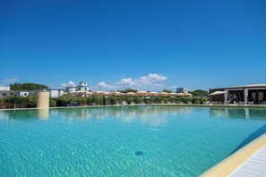 Seasonal outdoor pool, open 10:00 AM to 7:00 PM, pool umbrellas