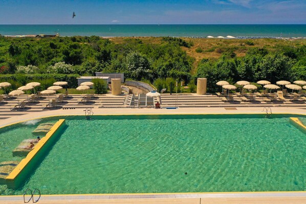 Seasonal outdoor pool, open 10:00 AM to 7:00 PM, pool umbrellas