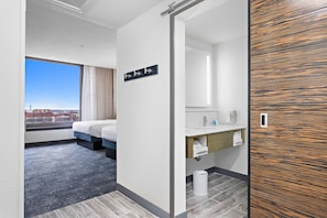 Enjoy a city view from the large window, a comfortable bed, and a compact bathroom with a separate area.