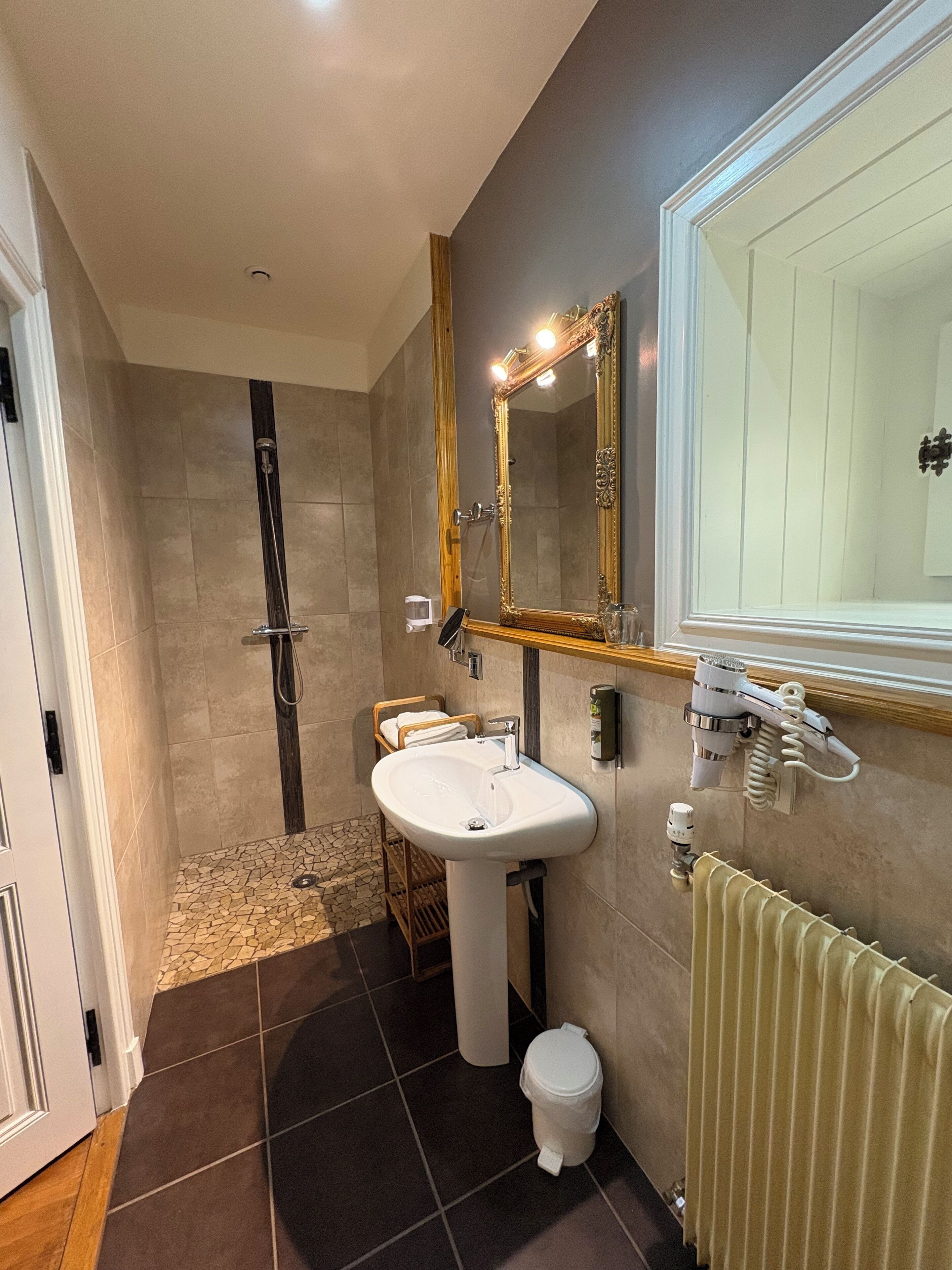 A bathroom with a shower, sink, and toilet.
