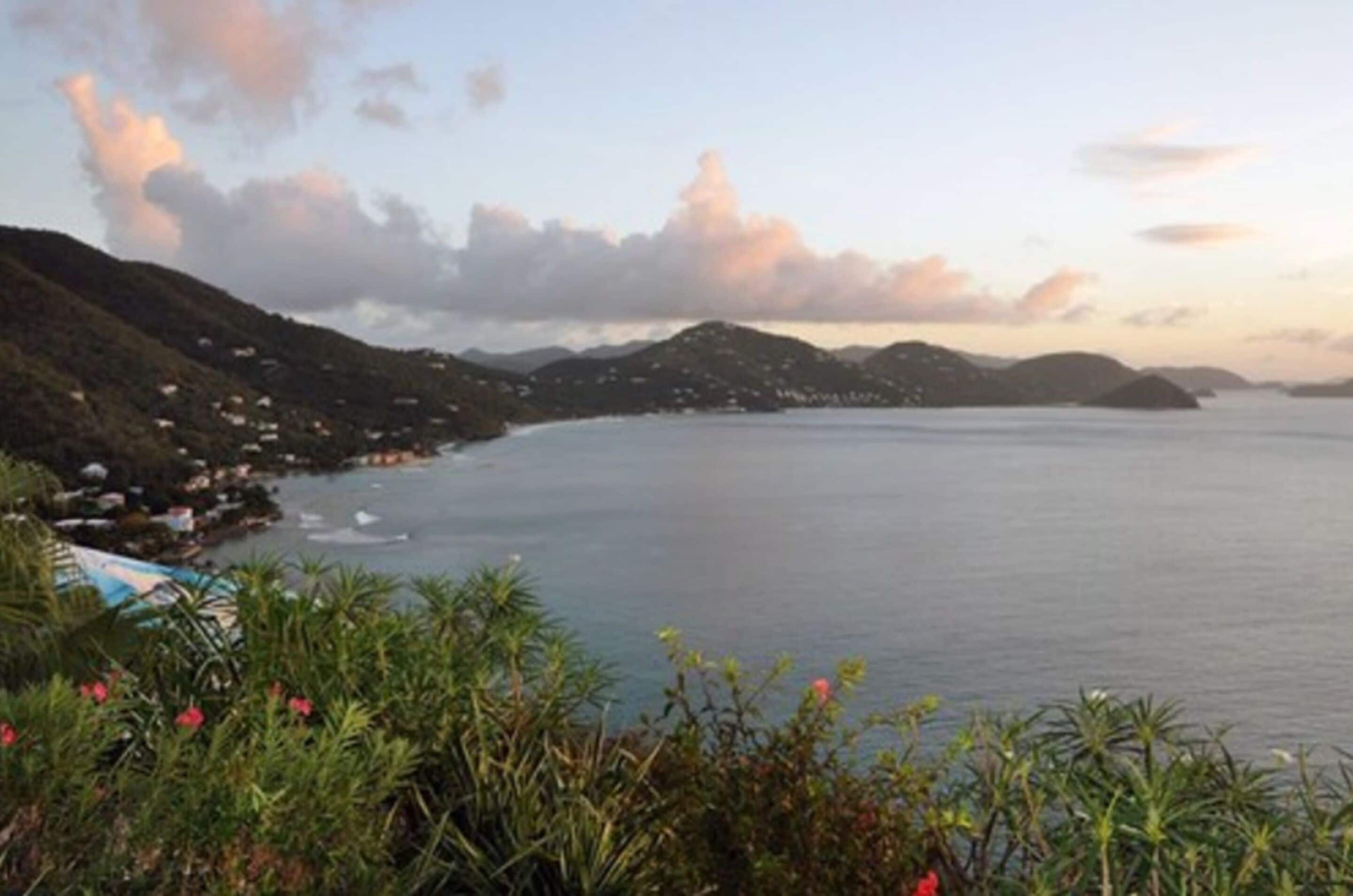 A coastal landscape with a view of the sea and hills.