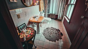 A compact bathroom with a sink, toilet, and mirror. - Historic Farnsworth House Inn (Gettysburg)
