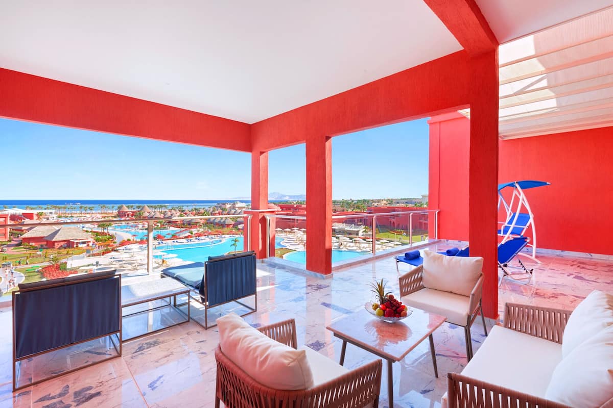 A spacious balcony with a clear view of a pool and resort area.
