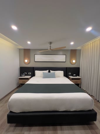 Desk, iron/ironing board, bed sheets