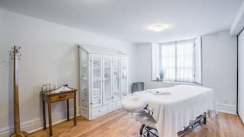 Enjoy a comfortable stay in this room with a large bed, wooden floor, and a convenient table for toiletries.