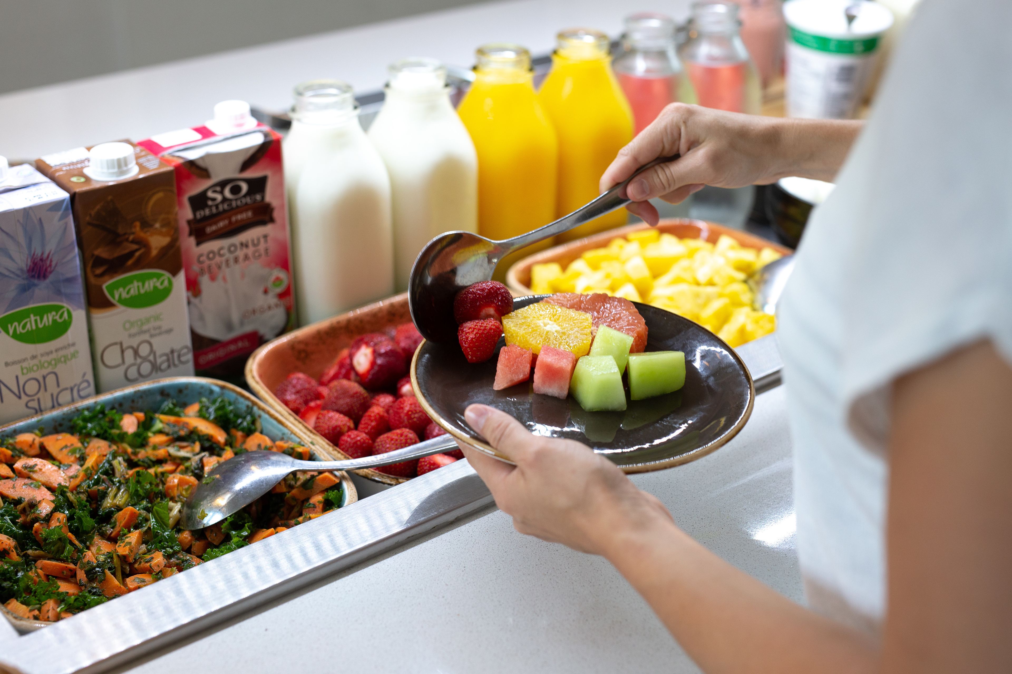 A buffet with various food items and beverages.