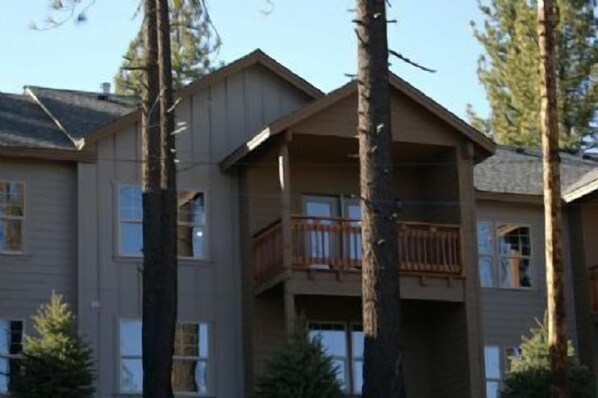 A multi-story building with a balcony on the second floor.