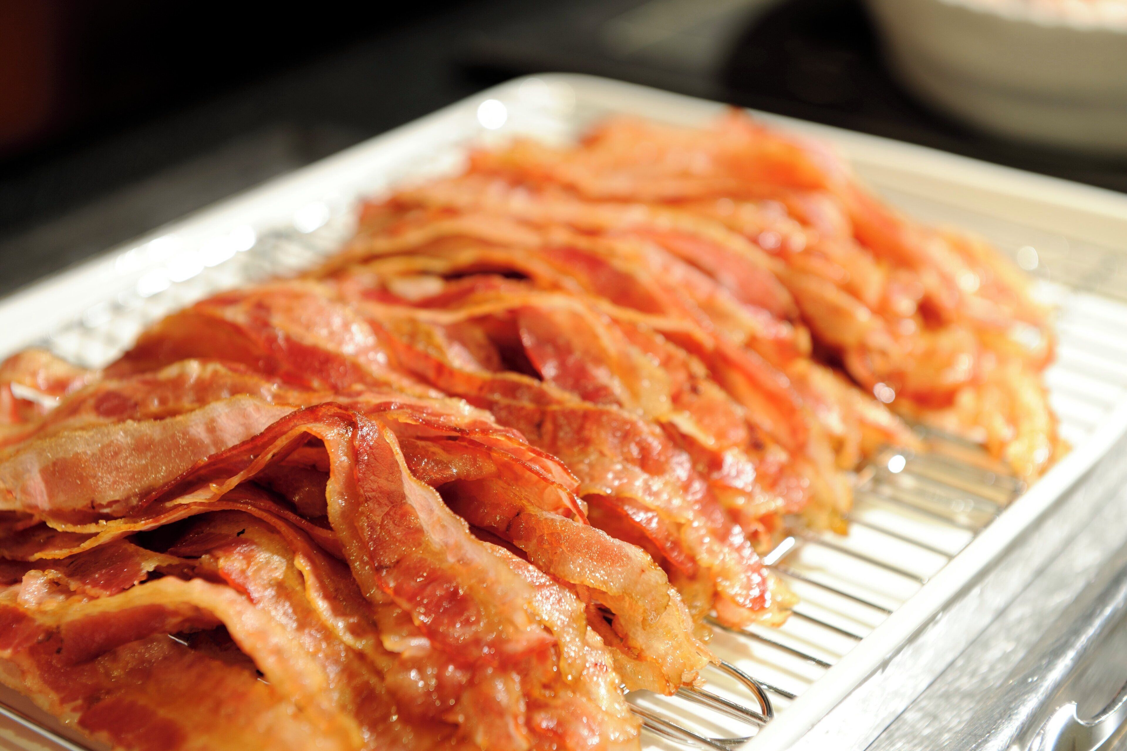 A tray of cooked bacon strips.