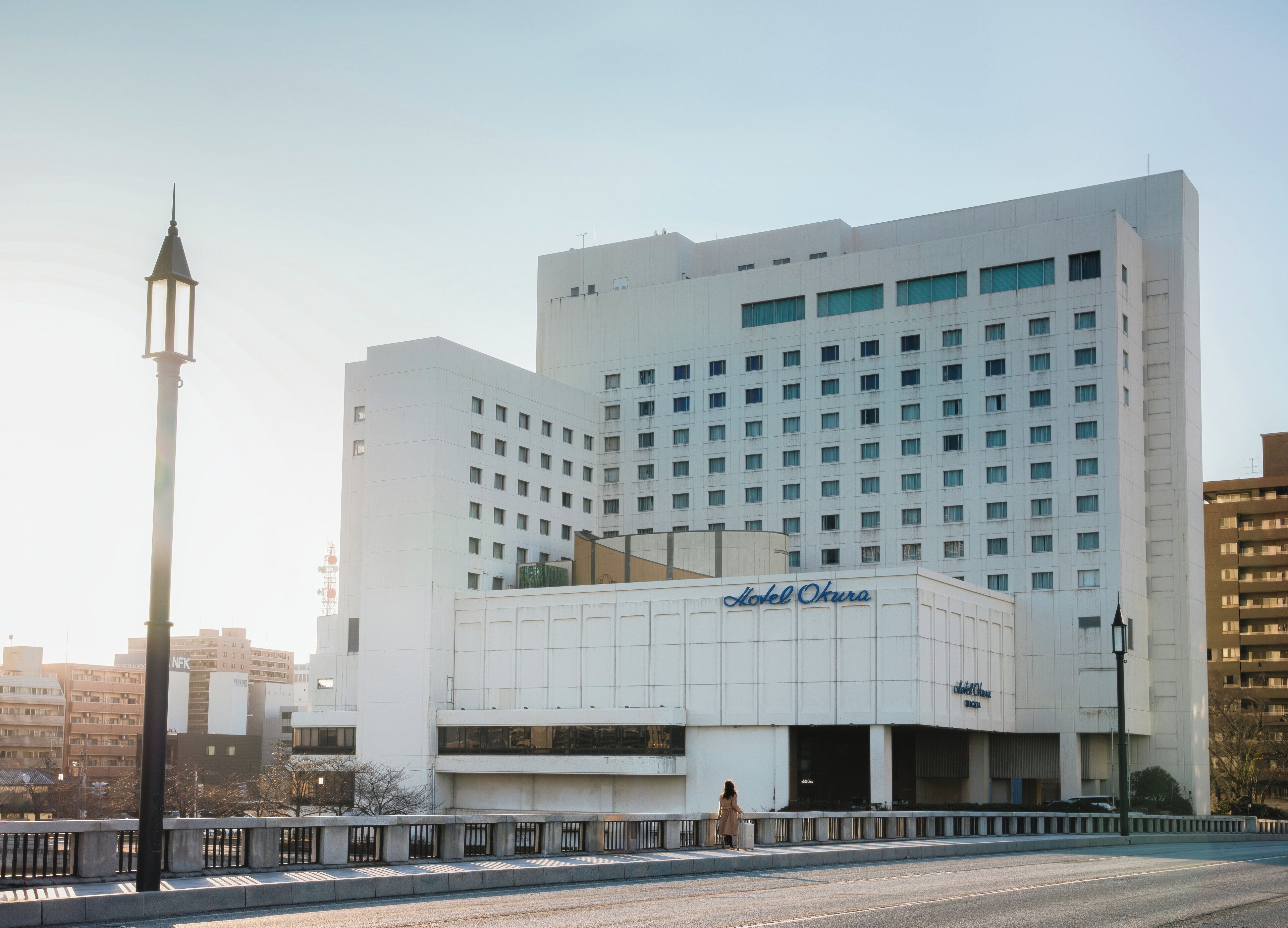 A multi-story hotel with a prominent entrance and a large sign.