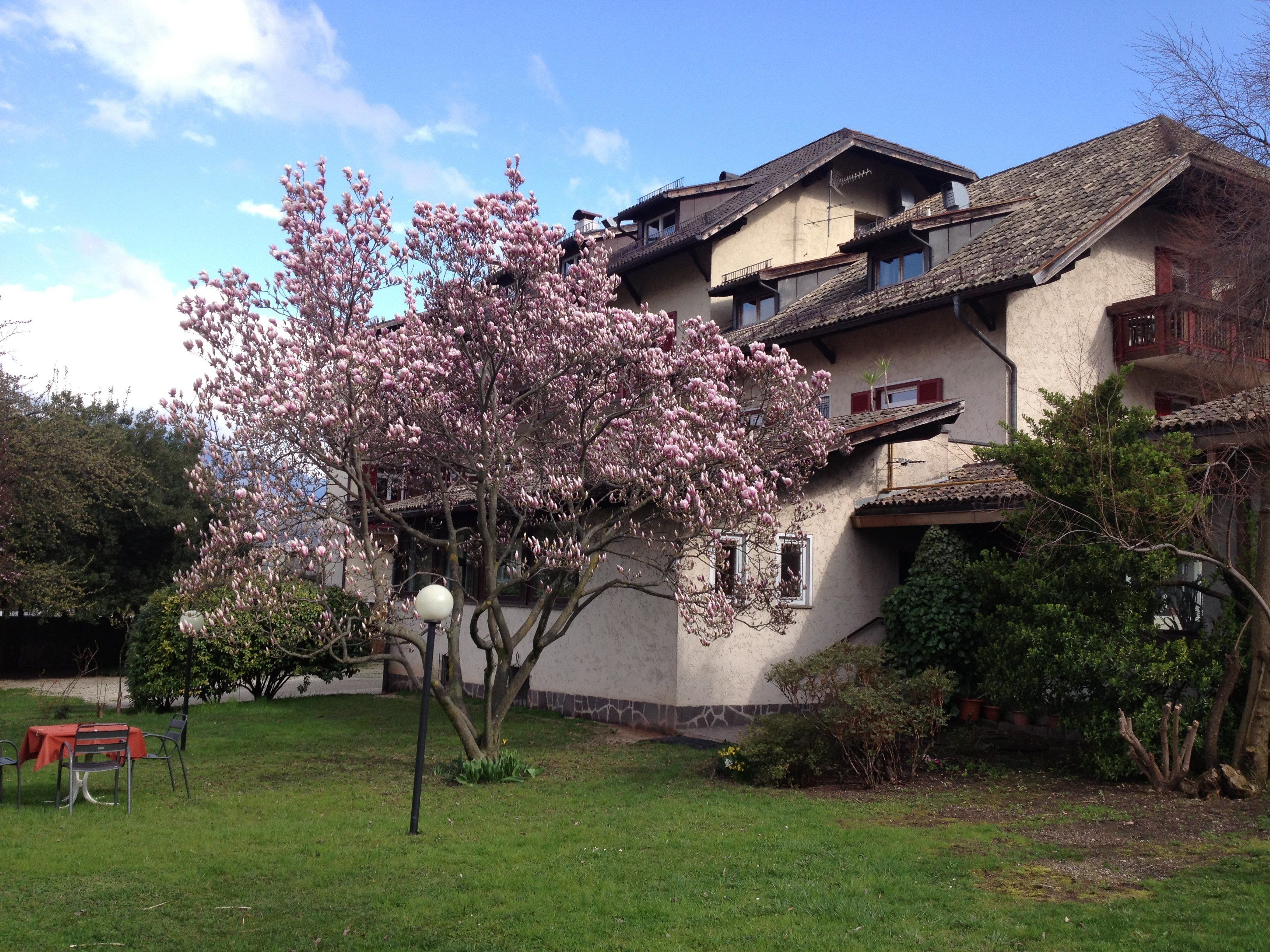 A two-story building with a traditional architectural style, featuring a balcony on the upper floor.