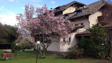 A two-story building with a traditional architectural style, featuring a balcony on the upper floor.