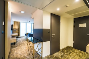 Relax in a serene space with a desk for work and a window offering a view of the outside.