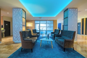 Relax in the stylish lobby with a seating area featuring two sofas and two armchairs.
