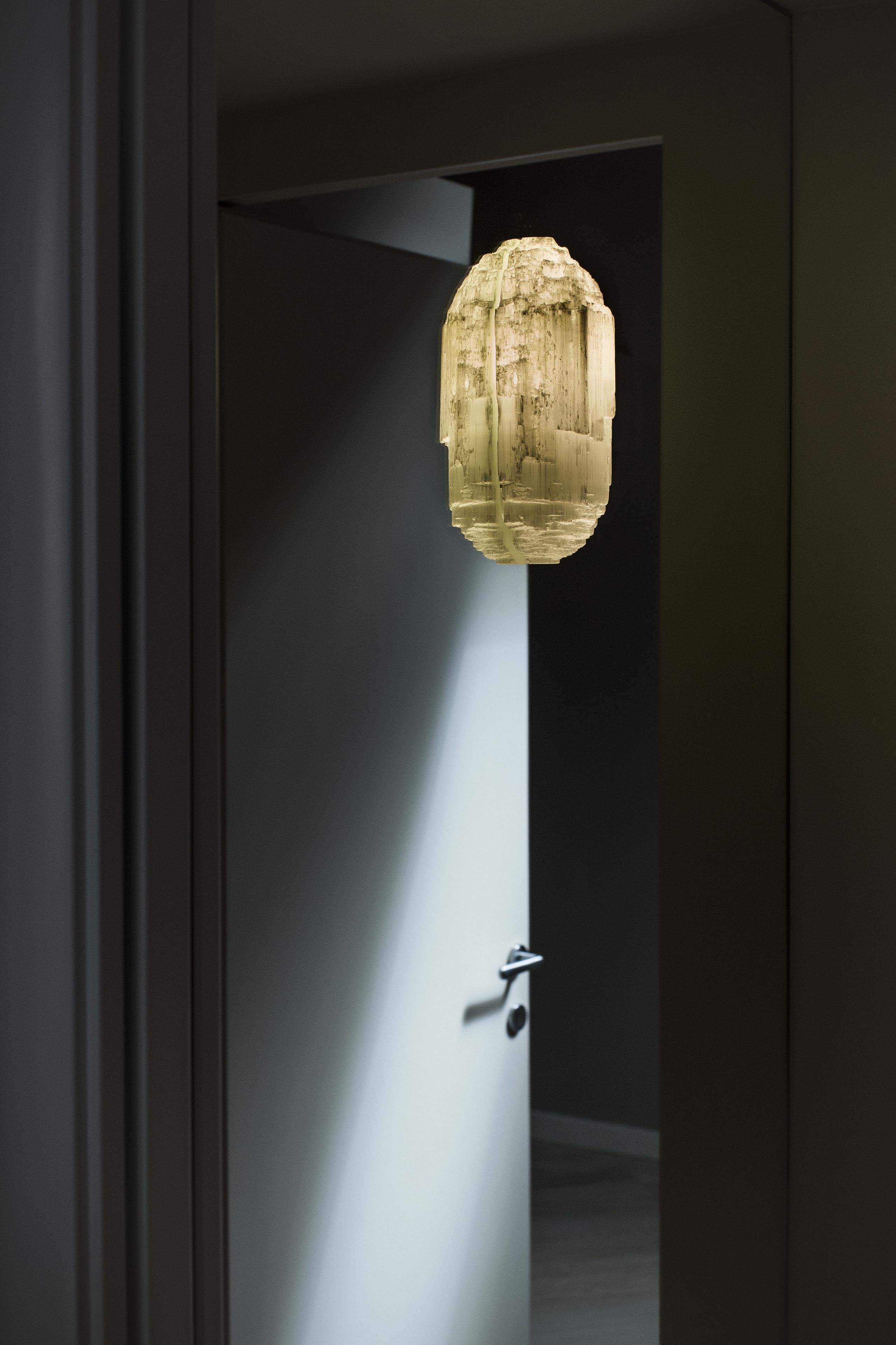 A modern interior with a door leading to a room.