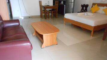 Standard Quadruple Room | Living area | 32-inch flat-screen TV with cable channels, TV, fireplace