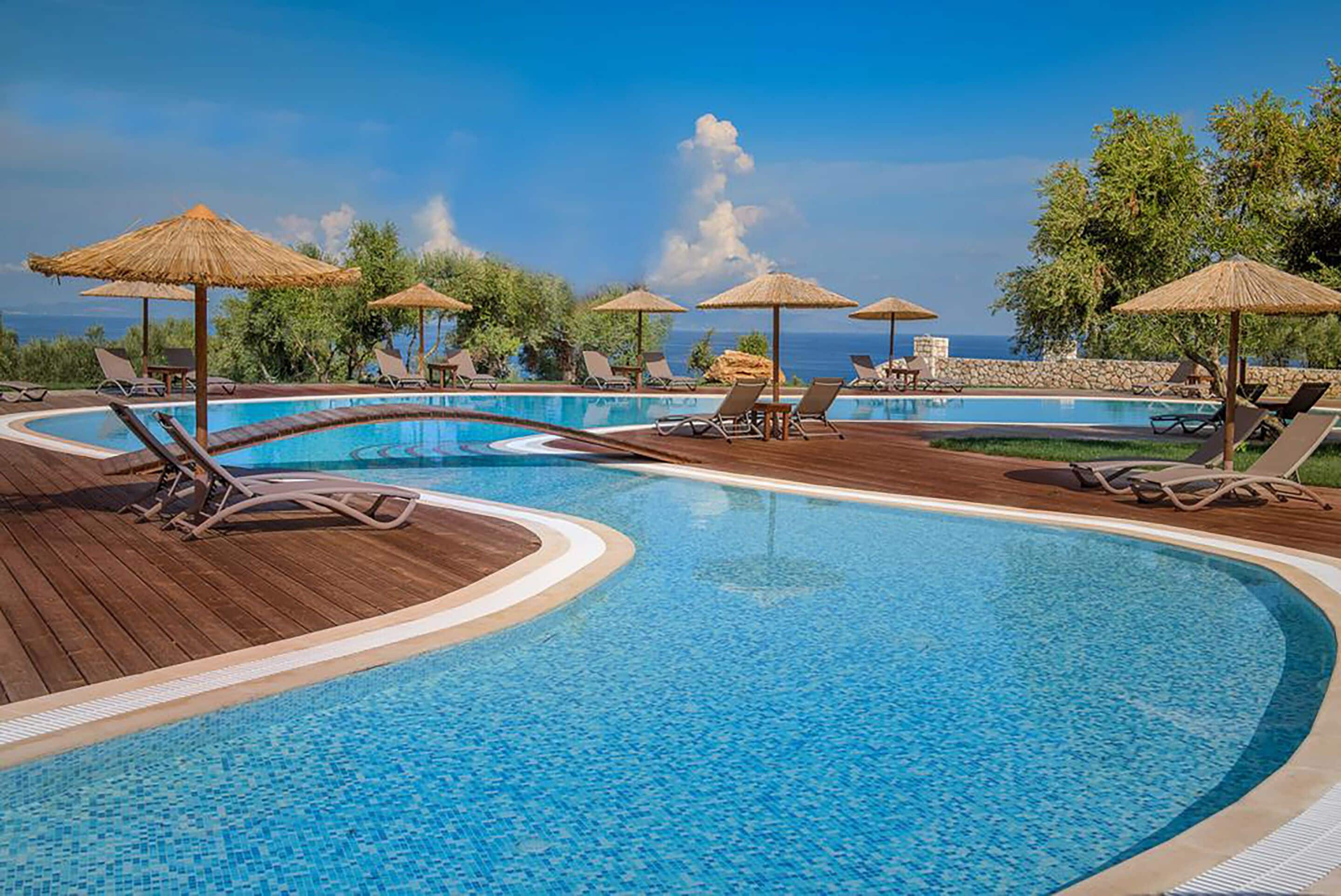 Outdoor pool, an infinity pool, pool umbrellas, sun loungers