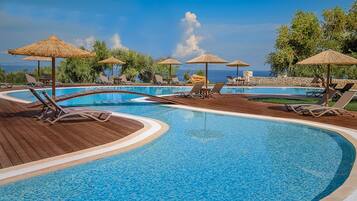 Outdoor pool, an infinity pool, pool umbrellas, pool loungers