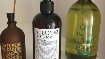 Three bottles of liquid products on a white surface.