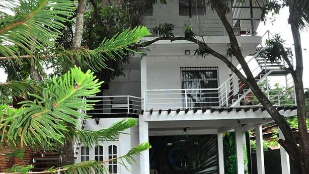 A two-story building with a balcony and a covered entrance. - City Resort (Anuradhapura)