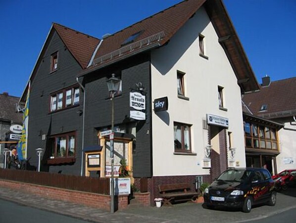 Stylish building with a traditional pitched roof and multiple windows, home to the 'Sky' business.
