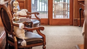A wooden interior with a large door leading to a balcony. - The Brewster Inn (Cazenovia)