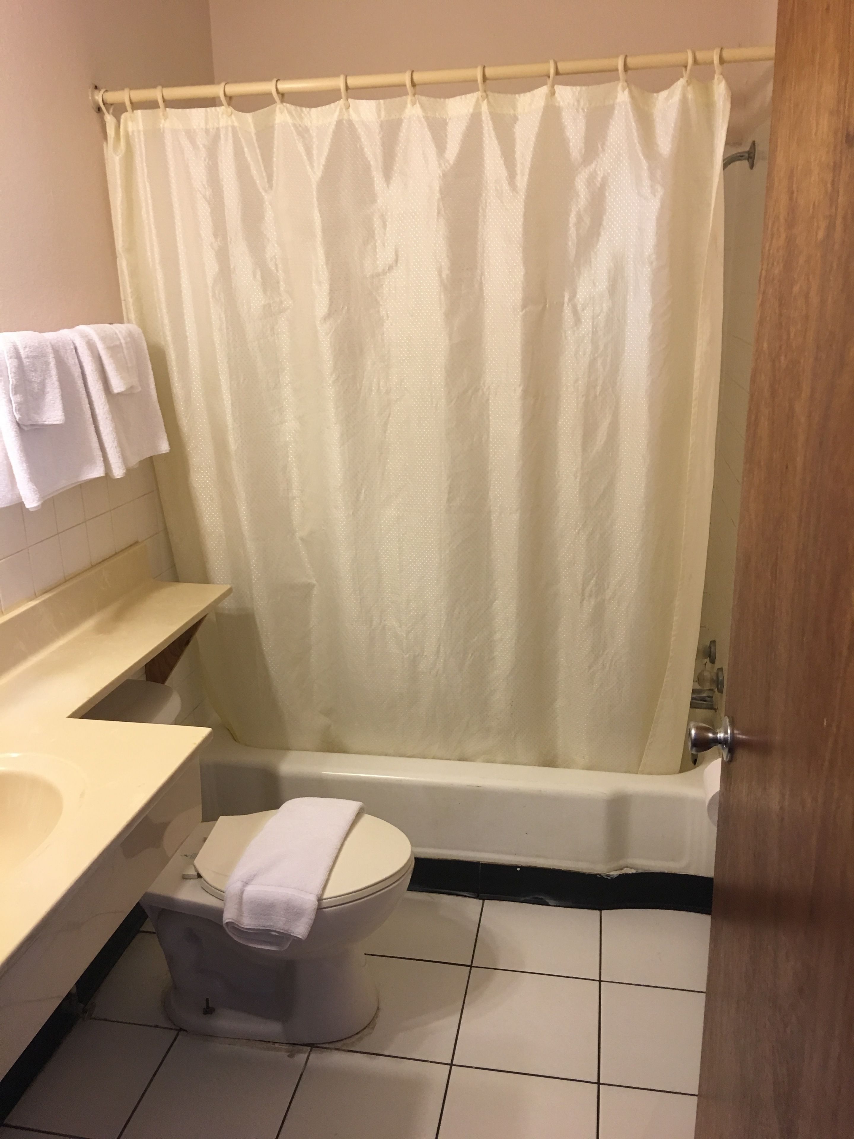 A bathroom with a bathtub, toilet, and sink.