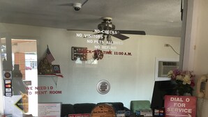 A reception desk with a sign indicating no visitors, no pets allowed, and no refund. - Best Value Inn Motel Sandusky (Marianna)