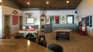 A pool table, billiards equipment, and a bar area with a wooden ceiling and walls. - River Bend's Resort (Baudette)