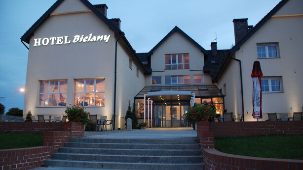 A hotel with a sign reading "HOTEL Bielany," featuring a traditional architectural style with a prominent entrance and steps leading up to the main door. - Hotel Bielany (Kobierzyce)