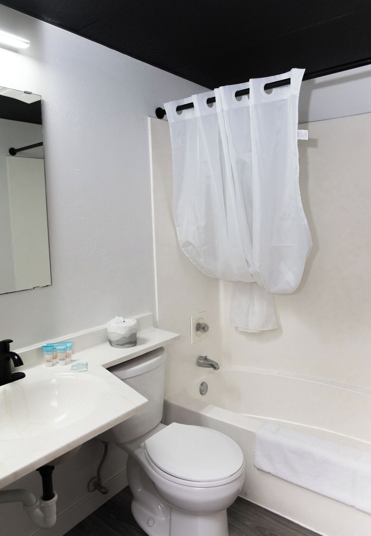 A bathroom with a white sink, toilet, and bathtub.