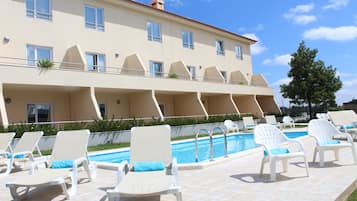 Seasonal outdoor pool, pool loungers