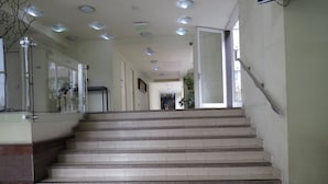 A staircase with a handrail, leading to a landing with glass doors. - Alojamientos Santiago Chile (Santiago)