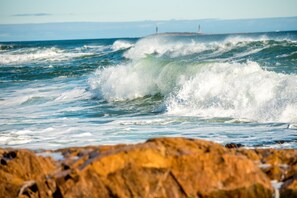 A rocky shoreline with waves crashing onto the rocks.