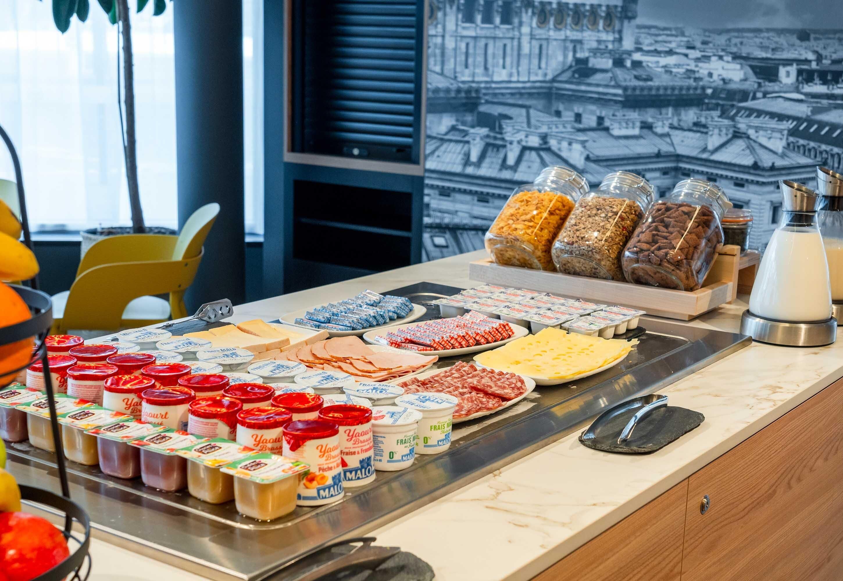A breakfast buffet with various food items and condiments.
