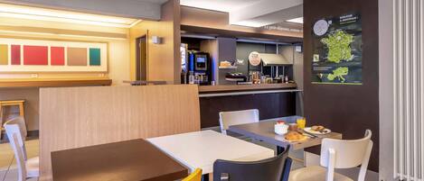A restaurant with tables and chairs, a counter with a menu, and a wall with a map.