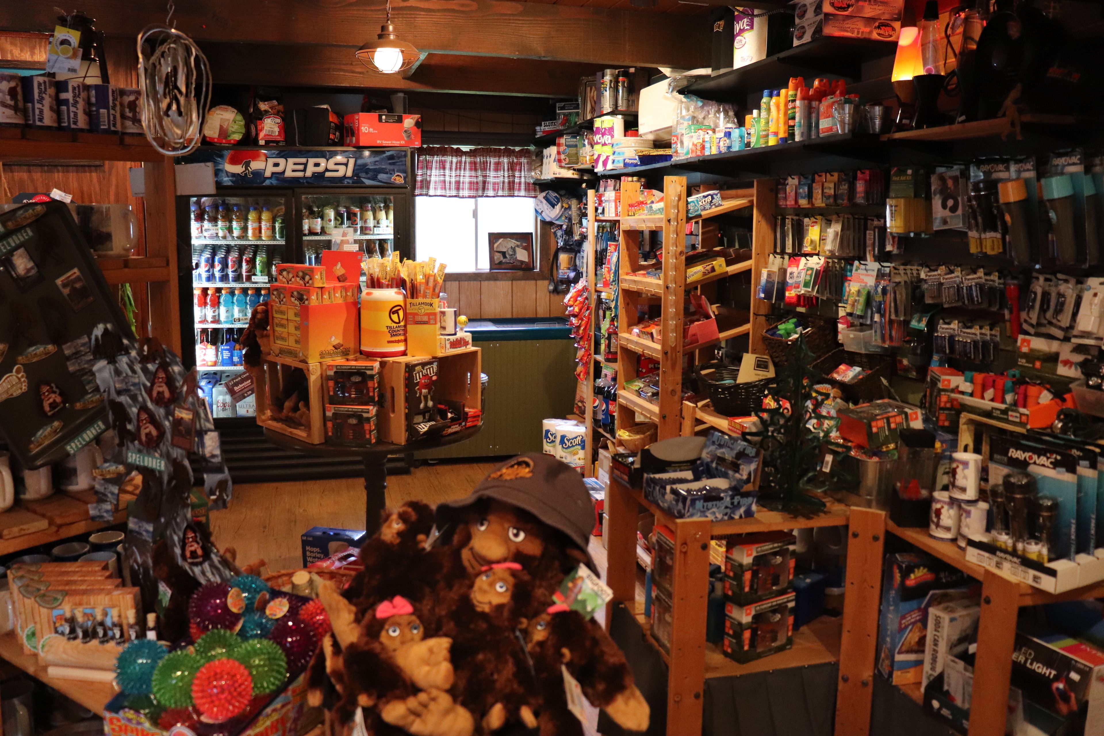 A store with shelves stocked with various items, including snacks and beverages.
