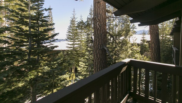 A wooden deck with a view of a forest and a mountain in the distance. - Mammoth Point by 101 Great Escapes (Mammoth Lakes)
