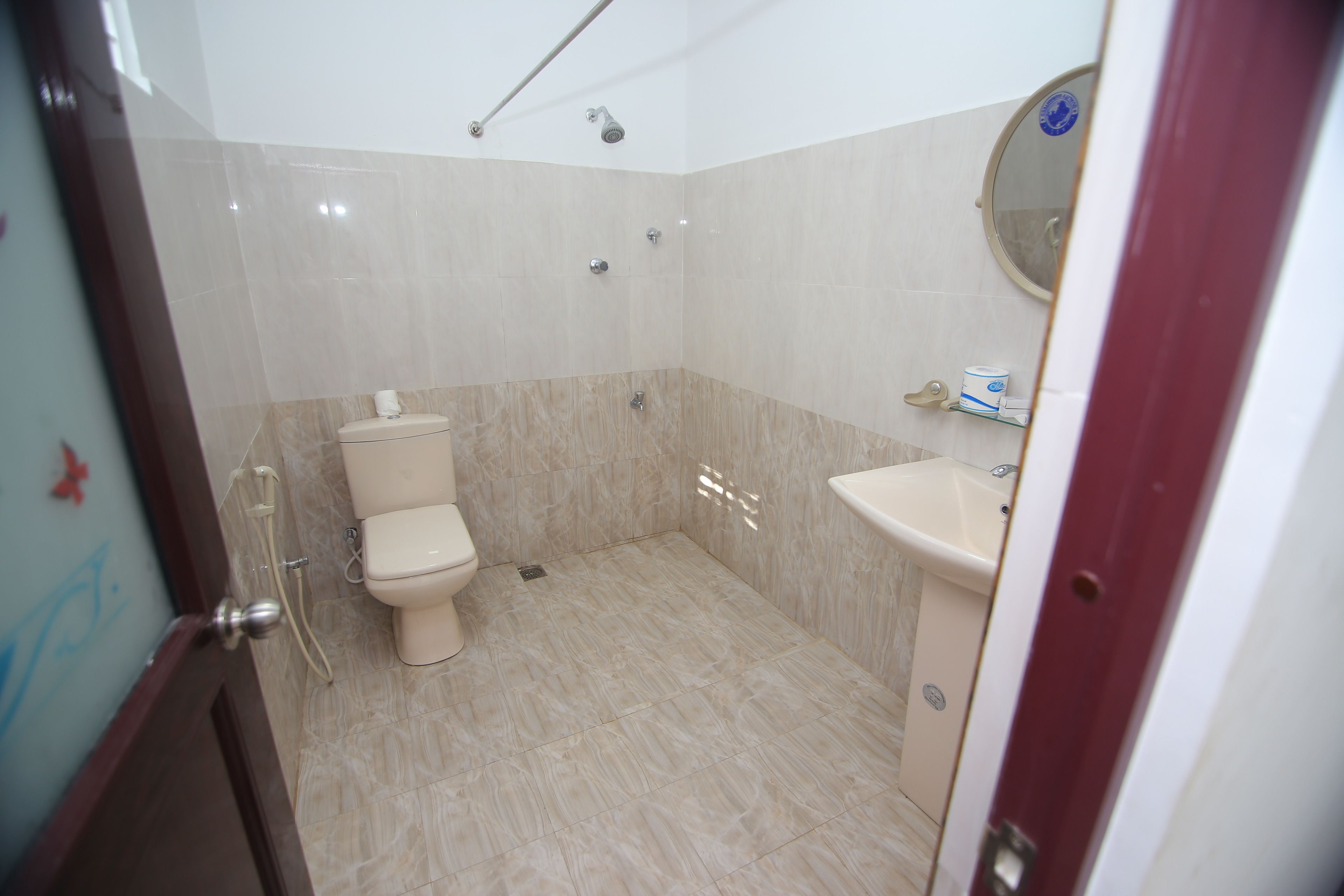 A bathroom with a toilet, sink, and shower.
