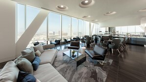 A spacious living area with a large sofa, coffee table, and multiple chairs. There are large windows offering a city view. - InterContinental Los Angeles Downtown by IHG (Los Angeles)