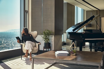 A rooftop bar with modern seating, a bar area, and a view of the city at night. at InterContinental Los Angeles Downtown by IHG