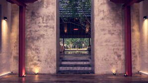 A wooden staircase leading to a covered outdoor area with a view of greenery. - Pledge3 (Negombo)