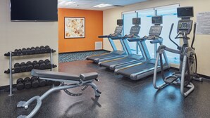 A gym with treadmills, an elliptical, a bench, and dumbbells. - Fairfield Inn & Suites Rawlins (Rawlins)